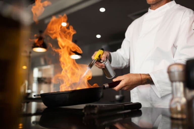 Side view of a chef preparing a meal at the counter