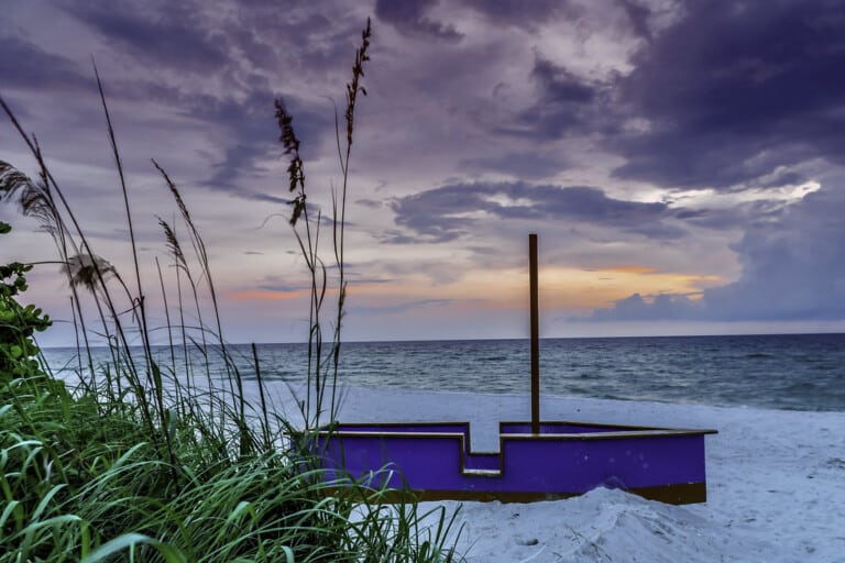 Sunset over the Gulf Coast beach with palm trees