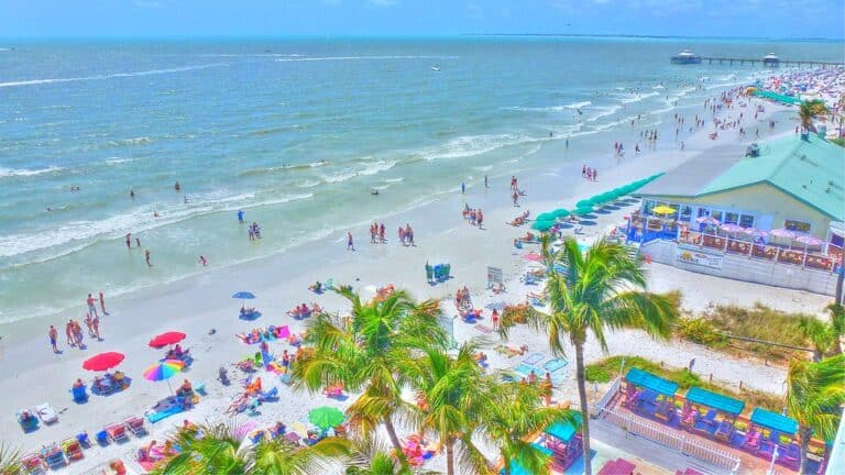 Aerial view of Fort Myers Beach shoreline with umbrellas and turquoise Gulf water