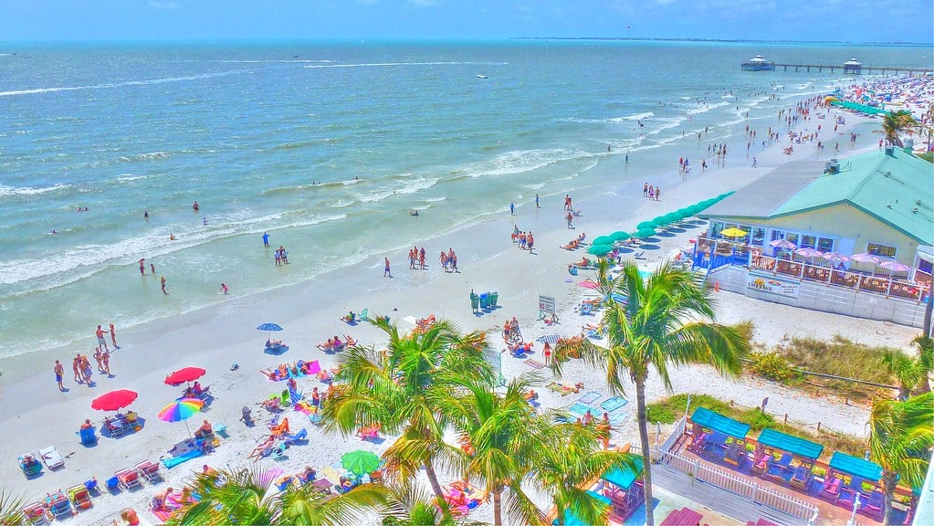Aerial view of Fort Myers Beach shoreline with umbrellas and turquoise Gulf water