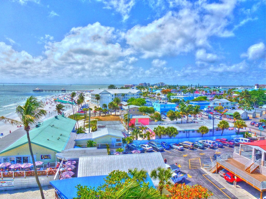 Aerial view of the Times Square district at Fort Myers Beach with colorful rooftops and the Gulf beyond