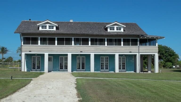 The restored 1921 Mound House sitting on its lawn above Estero Bay at Fort Myers Beach
